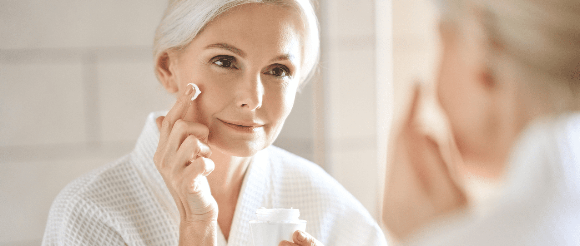 woman who applies an anti-aging cream to slow the appearance of wrinkles