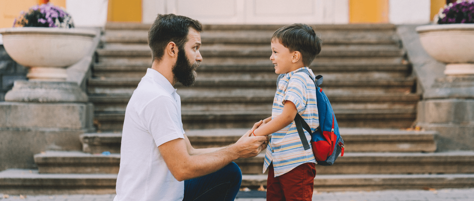 child going back to school with his father